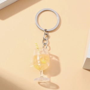 Close-up of a luminous goblet keychain with lemon slices, ice cubes and straw
