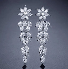 Close-up of elegant floral silver drop earrings with marquise-cut sparkling zircons