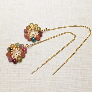 Detail view of tourmaline color beads hand-wrapped in 14K gold wire with long chains