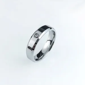 Polished silver stainless steel ring with faceted edges and a single inset zircon stone