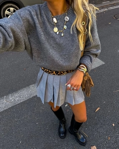 Street style fashion shot of grey knitted sweater paired with leopard belt and black boots