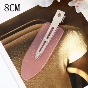 Detail of 8cm pink resin hair clip with gold glitter and silver metal alligator grip