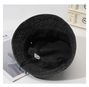 Detailed interior of 100% cotton bucket hat showing sweatband and washing label info