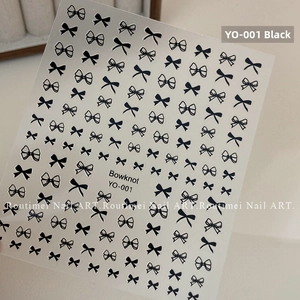 Detail view of black bowknot nail stickers featuring multiple sizes and line art designs