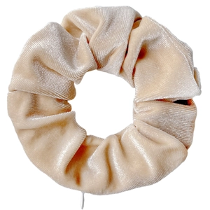 Close-up of beige velvet scrunchie showing soft texture and premium glossy fabric