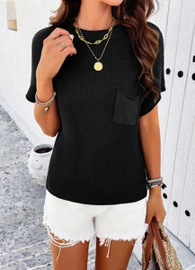 Detail of black short-sleeve knit top with chest pocket and white frayed denim shorts