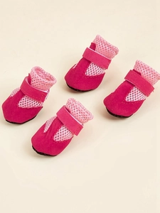 Detail of four breathable mesh dog shoes in pink with adjustable hook and loop straps