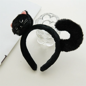 Detail of plush black cat headband with cute pink ears and curled tail for costume