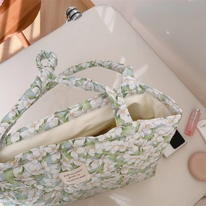 Detail of floral quilted cotton tote bag with soft fabric texture and canvas lining