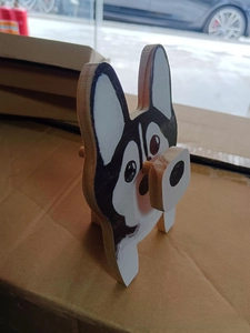 Detailed view of husky shaped wooden glasses holder with hand-painted artistic finish