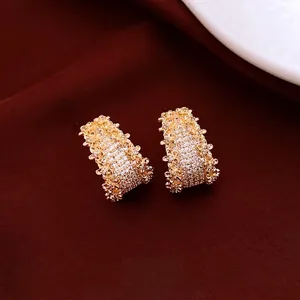 Vintage 14K gold plated C-shaped hoop earrings with micro-pave crystals on red velvet