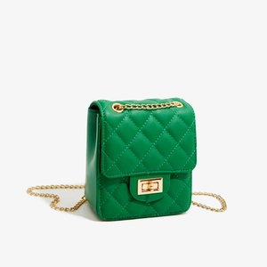 Detailed macro view of the green quilted PU leather mini bag with golden chain and clasp