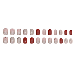 Short square press-on nails set in reddish-brown, pink, and silver glitter finishes