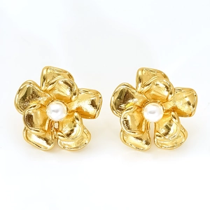 Elegant gold flower stud earrings with pearl centers and vintage hammered texture detail