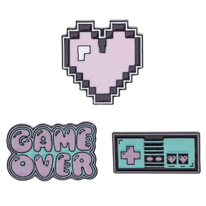 Three-piece set of retro pixel art enamel pins featuring heart, gamepad, and game over text