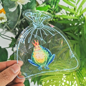 Close-up of rainbow suncatcher glass sticker with crown frog prince design