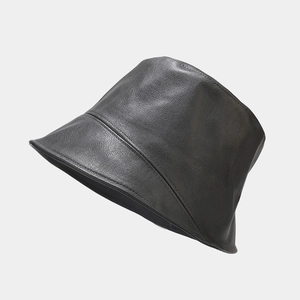 Detailed view of black PU leather bucket hat with precise stitching and minimalist texture