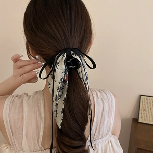 Rear view of a black hair claw clip featuring ribbon bow with Chinese calligraphy detail