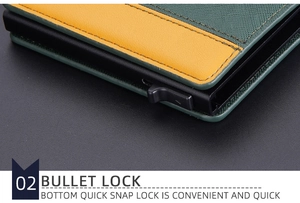 Detail view of the green fabric and yellow leather wallet with a quick snap bullet lock mechanism