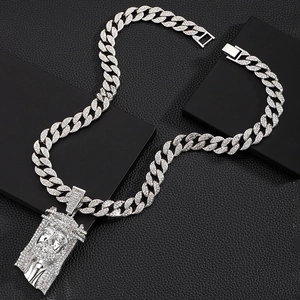 Close-up of silver hip hop Jesus head pendant with crystals on Cuban link chain