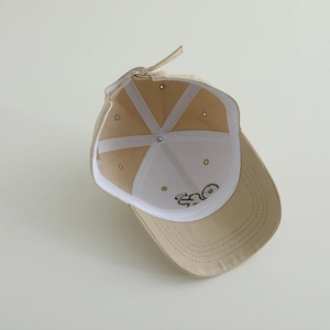 Detail showing the inner structure of a khaki cotton baseball cap with sweatband