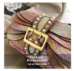 Detail showing colorful snakeskin pattern with pearls and crystals on the clutch