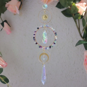 Detail of crystal suncatcher featuring golden moon and colorful stone elements
