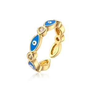 Macro shot of 18K gold plated evil eye open ring with blue enamel and zircon stones
