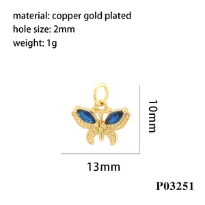 Detail of blue butterfly pendant with copper gold plating and zircon inlay, 13x10mm size