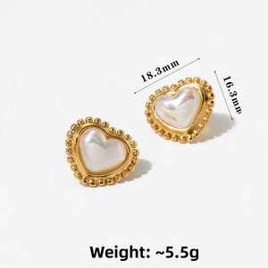 Detail view of heart-shaped earrings with gold frame and white shell texture inlay