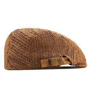 Detail of breathable straw beret hat showing woven texture and adjustable metal buckle