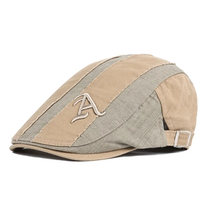 Detail of vintage patchwork flat cap with Letter A embroidery and linen texture fabric