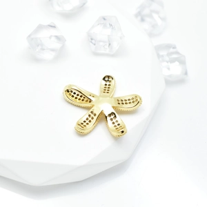 Golden micro-pave sunflower pearl pendant holder displayed on a clean white geometric base