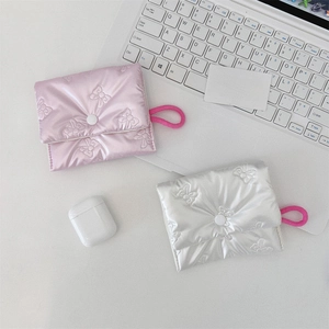 Detail of quilted satin mini pouches with bow embroidery in pink and silver