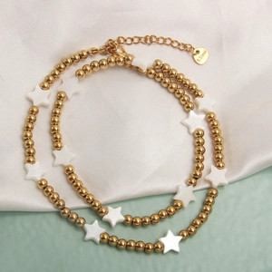 Minimalist gold beaded necklace with white star shell pendant in stainless steel