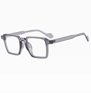 Detail of retro square sunglasses with translucent grey frames and silver metal studs