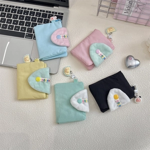 Close-up of fabric coin purses in five colors featuring cute animal charms and snap buttons