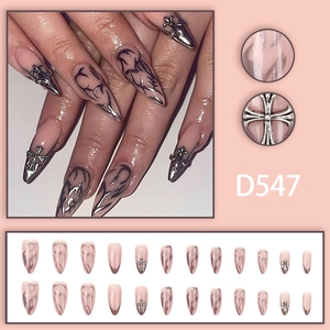 Dark aesthetic nude pink stiletto press-on nails with silver chrome flame and cross charms