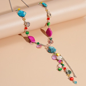 Detailed shot of bohemian long tassel necklace with colorful natural stones and shells