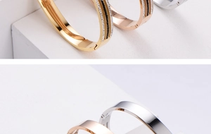 Macro shot of minimalist polished titanium steel bangles with hinged clasps and crystals
