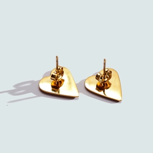 Detailed back view of gold heart stud earrings featuring secure butterfly push-back closures