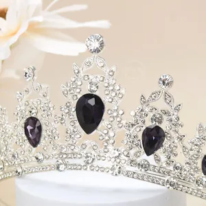 Detail of luxury crown with purple pear-shaped stones and shiny silver crystal rhinestones