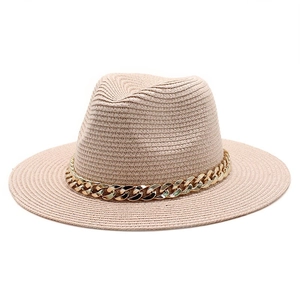 Detail view of the beige straw fedora hat featuring a stylish thick gold metal chain band