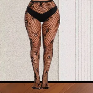 Gothic style black fishnet stockings featuring woven skull patterns and wide waistband