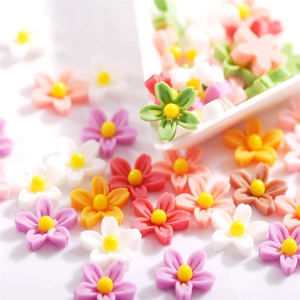 Close-up of colorful resin five-petal flowers for DIY nail art and decoration