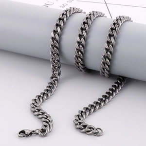 Close-up of vintage distressed stainless steel curb chain with secure lobster clasp