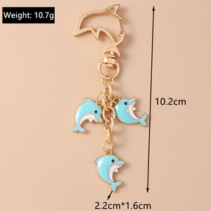 Detail view of a dolphin keychain with measurements and light blue enamel pendants