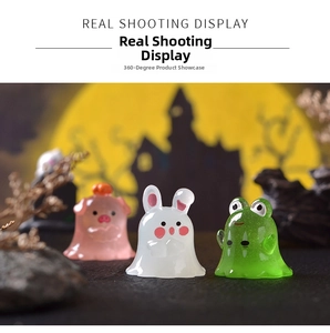 Close-up of Halloween ghost figurines featuring a pig, rabbit, and frog with a moon backdrop