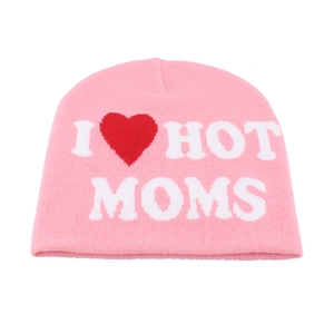 Close-up of pink knitted beanie with white I Heart Hot Moms lettering and red heart