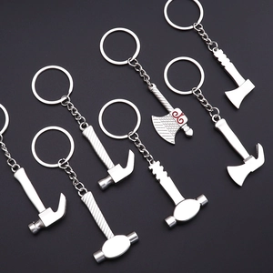 Miniature silver alloy tool keychain set featuring hammers and axes on black background